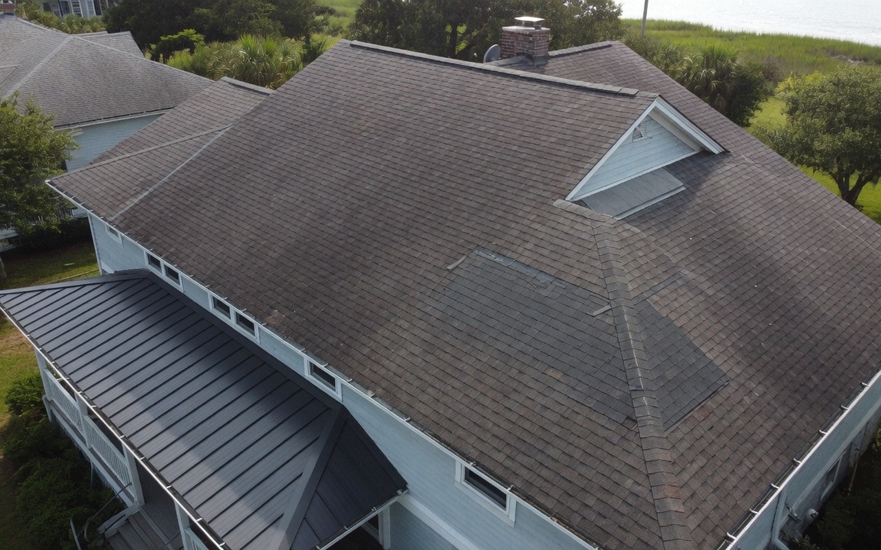 Coastal home roof showing a localized repair and metal roof upgrade