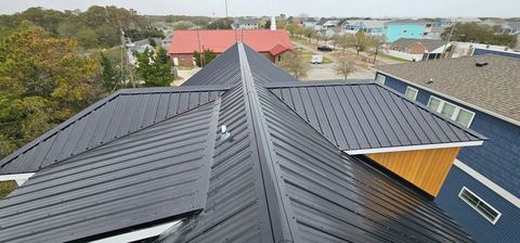 Finished dark metal roof in a coastal neighborhood