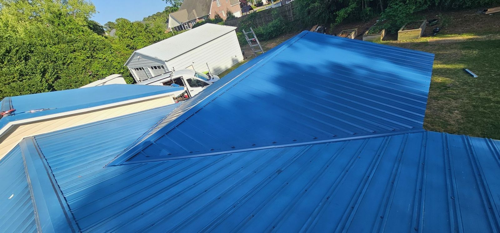 Blue metal roof panels on a residential roof slope