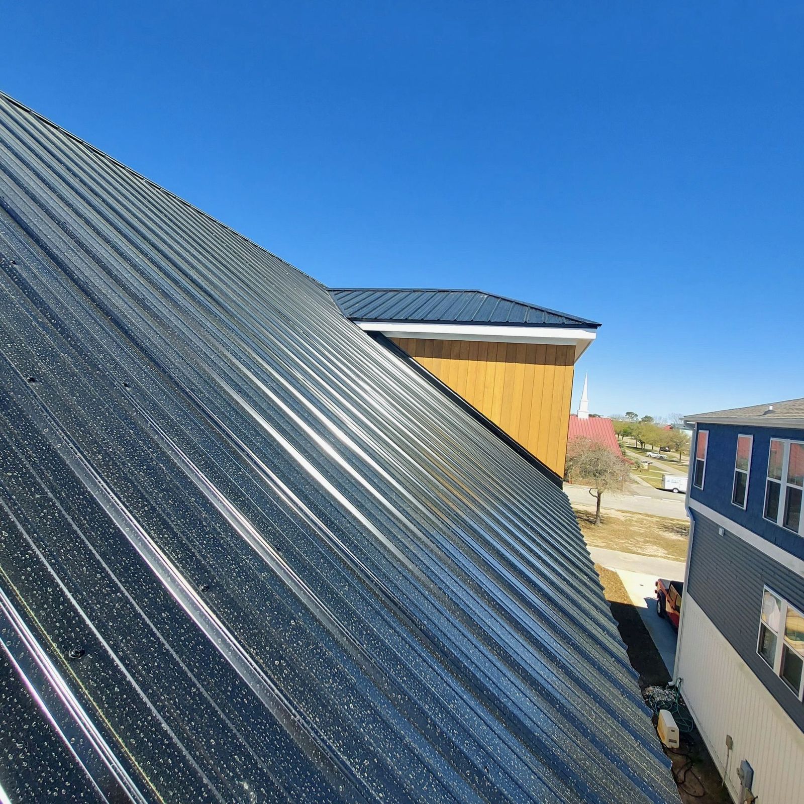 Metal roof panel detail under blue sky