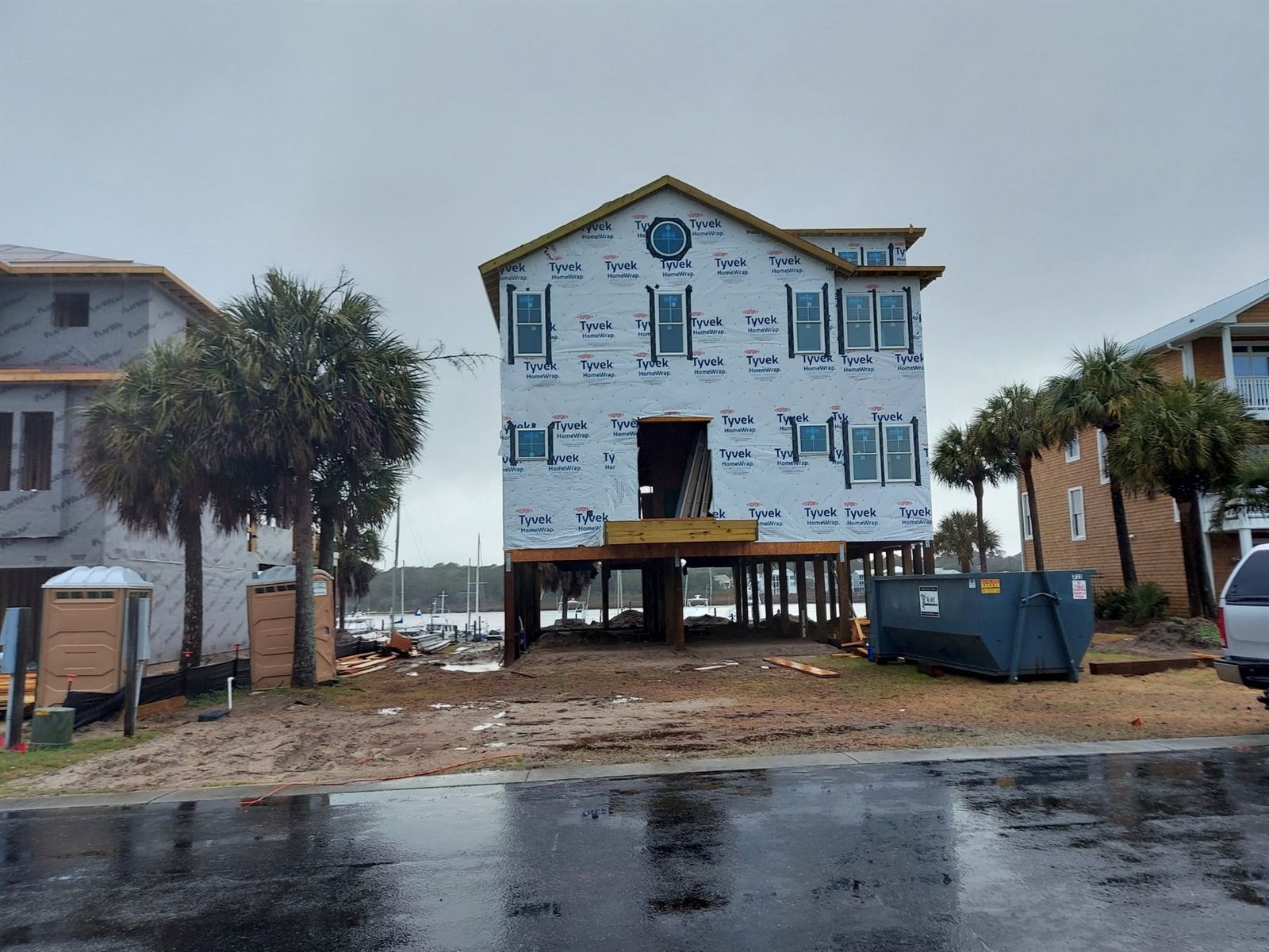 New construction home with house wrap during roofing prep